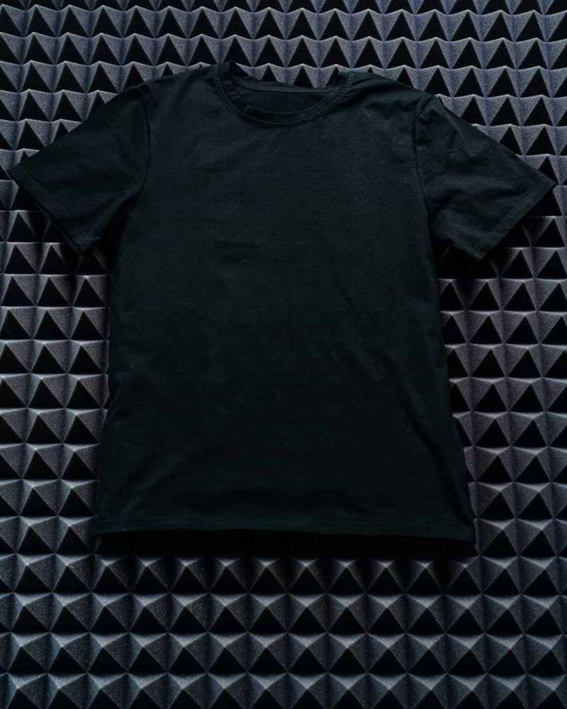 black-color-plain-t-shirt-on-textured-background.jpg